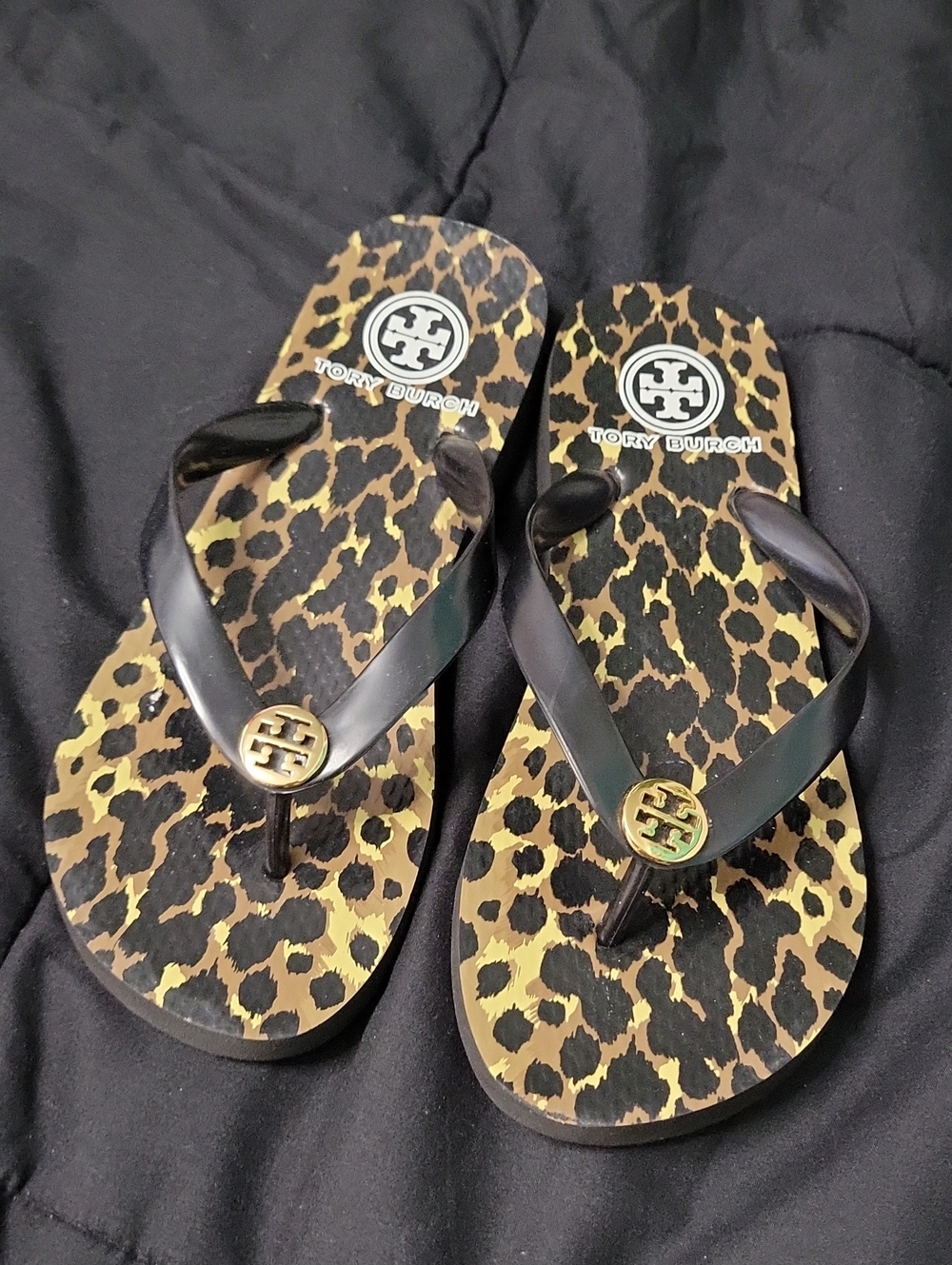 Tory Burch Leopard Print Slide Sandals in black.